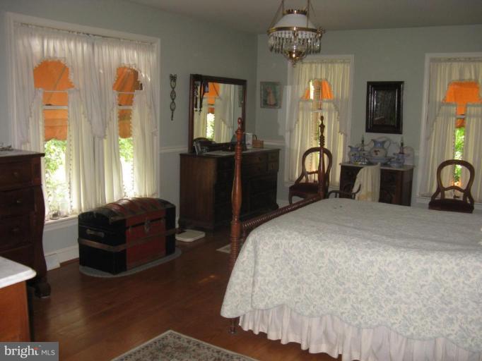 11625 Walnut Point Road Hagerstown, MD 21740 - Photo 14 of 25 a bedroom with a bed mirror and a window