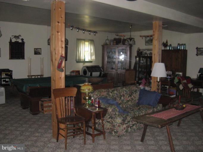 11625 Walnut Point Road Hagerstown, MD 21740 - Photo 18 of 25 a living room with furniture and wooden floor