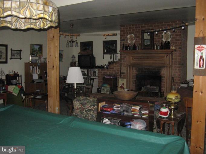 11625 Walnut Point Road Hagerstown, MD 21740 - Photo 19 of 25 a living room with furniture and a fireplace