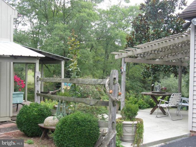 11625 Walnut Point Road Hagerstown, MD 21740 - Photo 22 of 25 a view of a patio with table and chairs potted plants