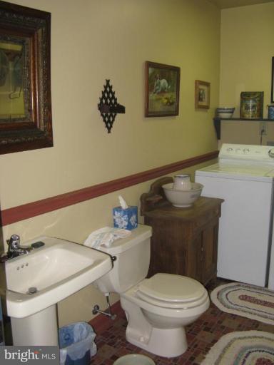 11625 Walnut Point Road Hagerstown, MD 21740 - Photo 24 of 25 a white toilet sitting next to a bathroom sink