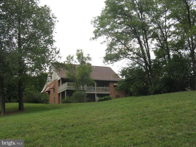 11625 Walnut Point Road Hagerstown, MD 21740 - Photo 8 of 25 a front view of a house with a yard and trees