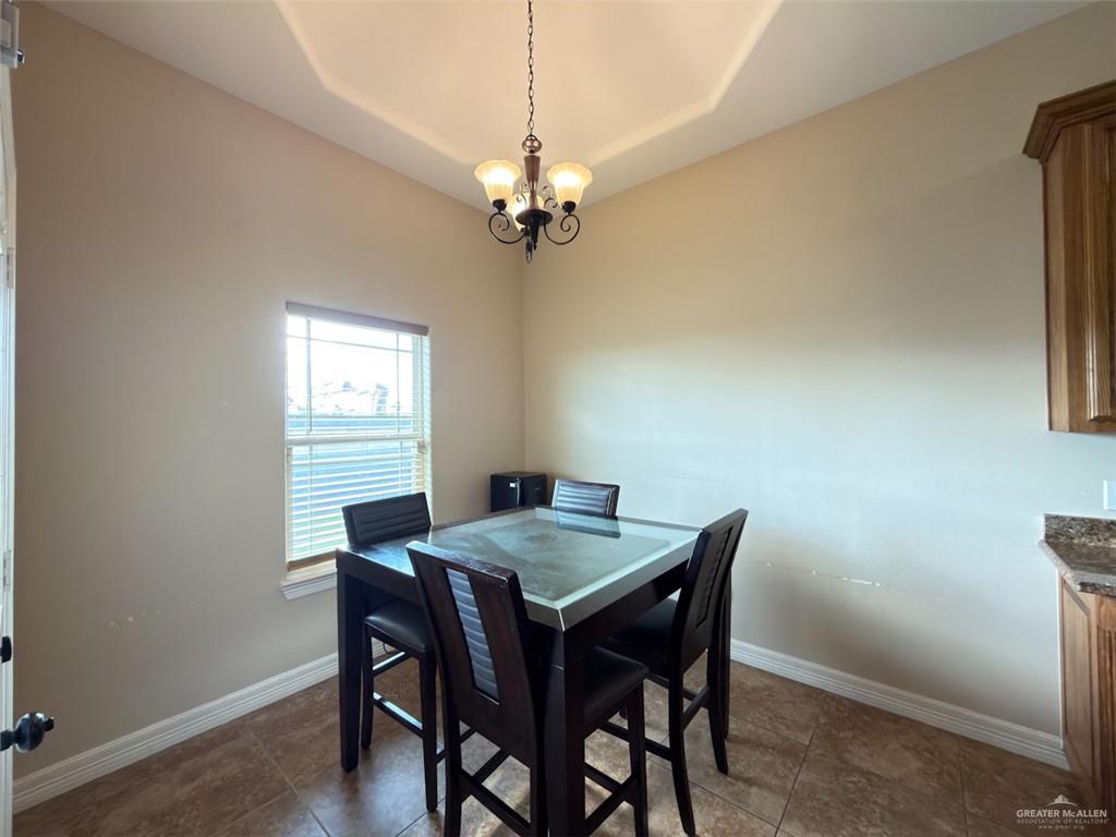208 North 15th Street Hidalgo, TX 78557 - Photo 23 of 26 a view of a dining room with a table and chairs