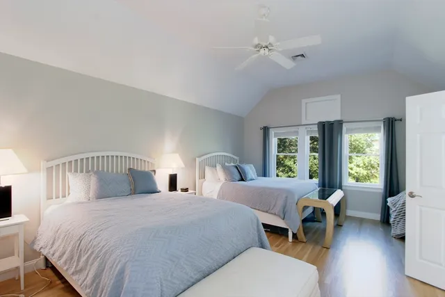 a bedroom with two beds and a large window