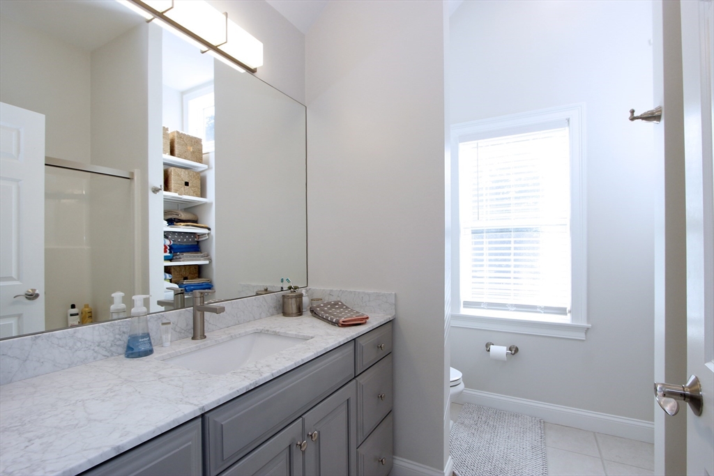 42 Fells Pond Road Mashpee, MA 02649 - Photo 18 of 35 a bathroom with a granite countertop sink and a mirror