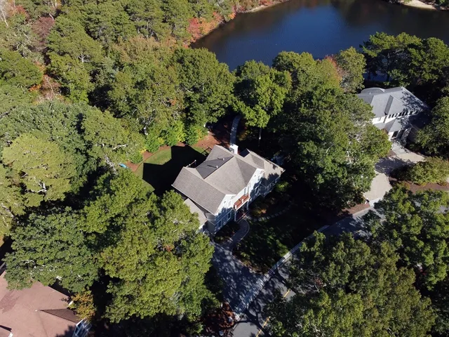 an aerial view of a house with a yard