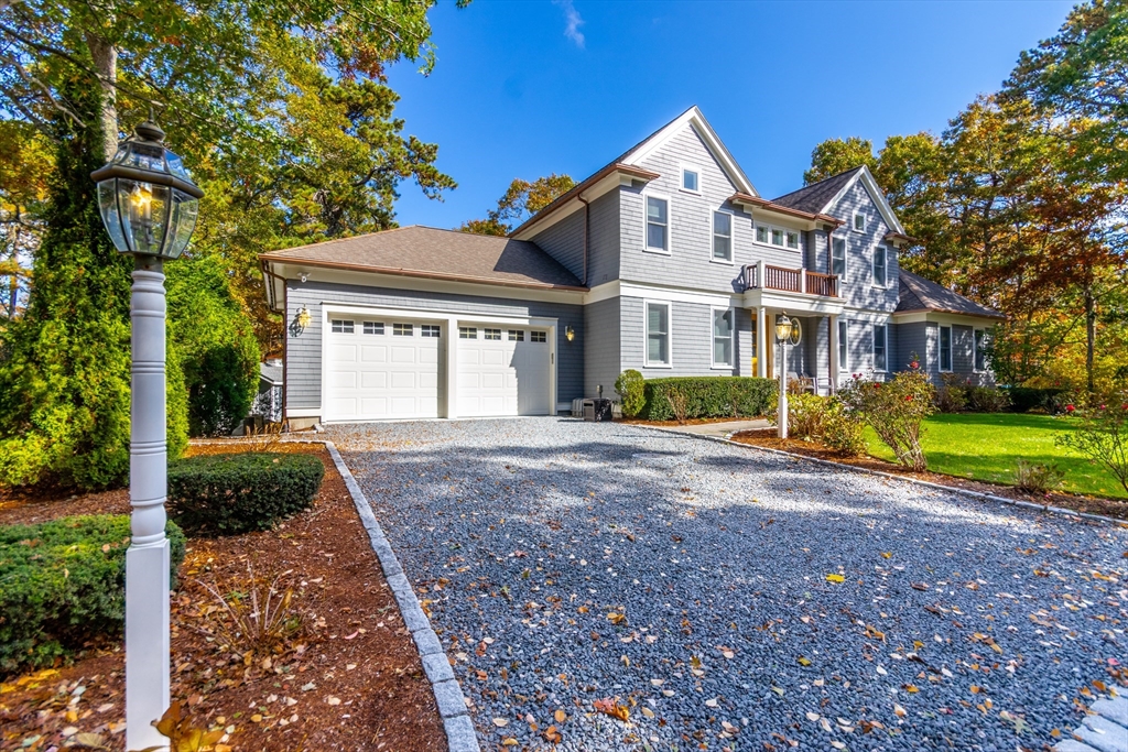 42 Fells Pond Road Mashpee, MA 02649 - Photo 24 of 35 a front view of a house with a yard and garage