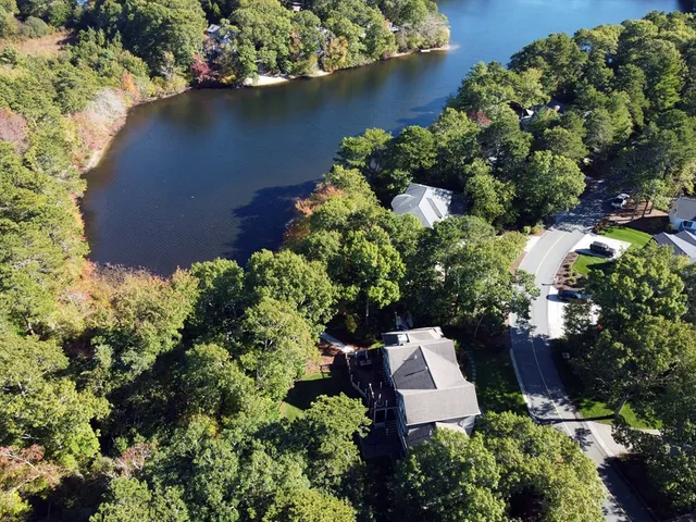 an aerial view of a house with a yard and garden