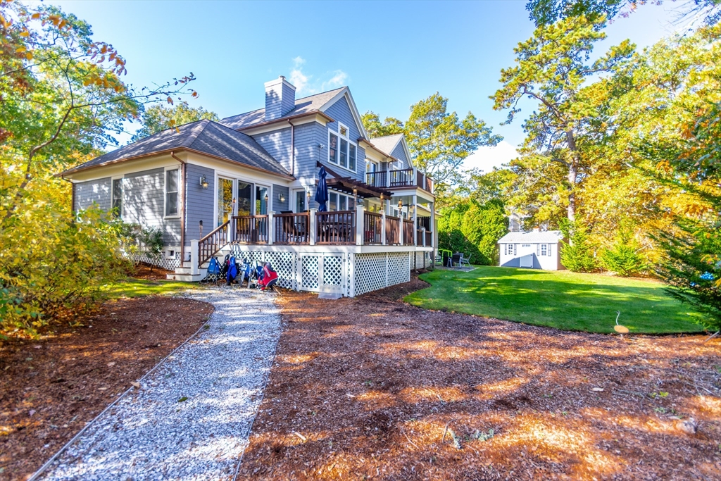 42 Fells Pond Road Mashpee, MA 02649 - Photo 28 of 35 a view of a big house with a big yard and large tree
