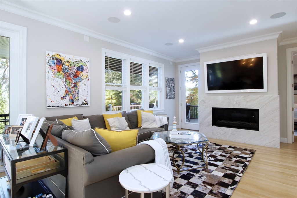 42 Fells Pond Road Mashpee, MA 02649 - Photo 6 of 35 a living room with furniture a flat screen tv and a fireplace