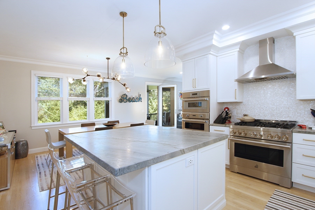 42 Fells Pond Road Mashpee, MA 02649 - Photo 9 of 35 a kitchen with a stove a microwave and wooden floor