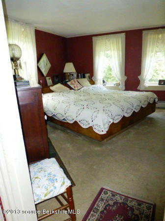 1475 Savoy Road Windsor, MA 01270 - Photo 27 of 61 a bed sitting in a bedroom next to a window