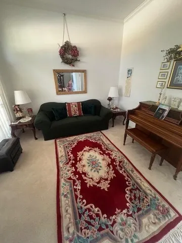 a bedroom with furniture and a rug