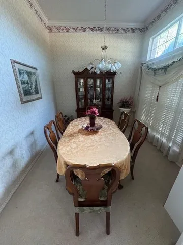 a dining room with furniture and window