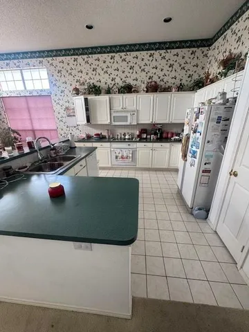 a view of kitchen sink and microwave