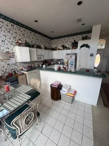a kitchen with a stove and white cabinets