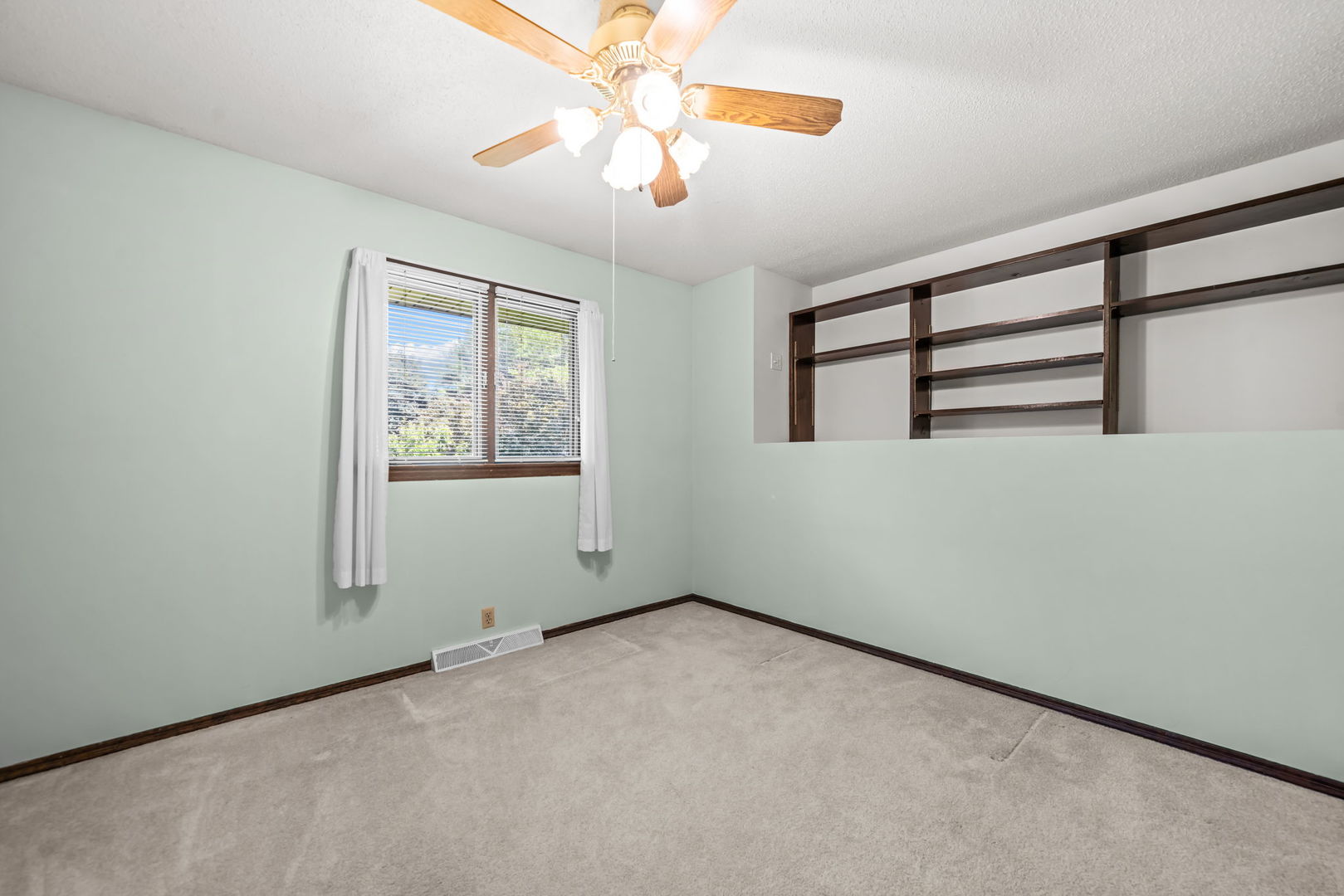 5748 South Skare Road Rochelle, IL 61068 - Photo 21 of 45 an empty room with windows and fan