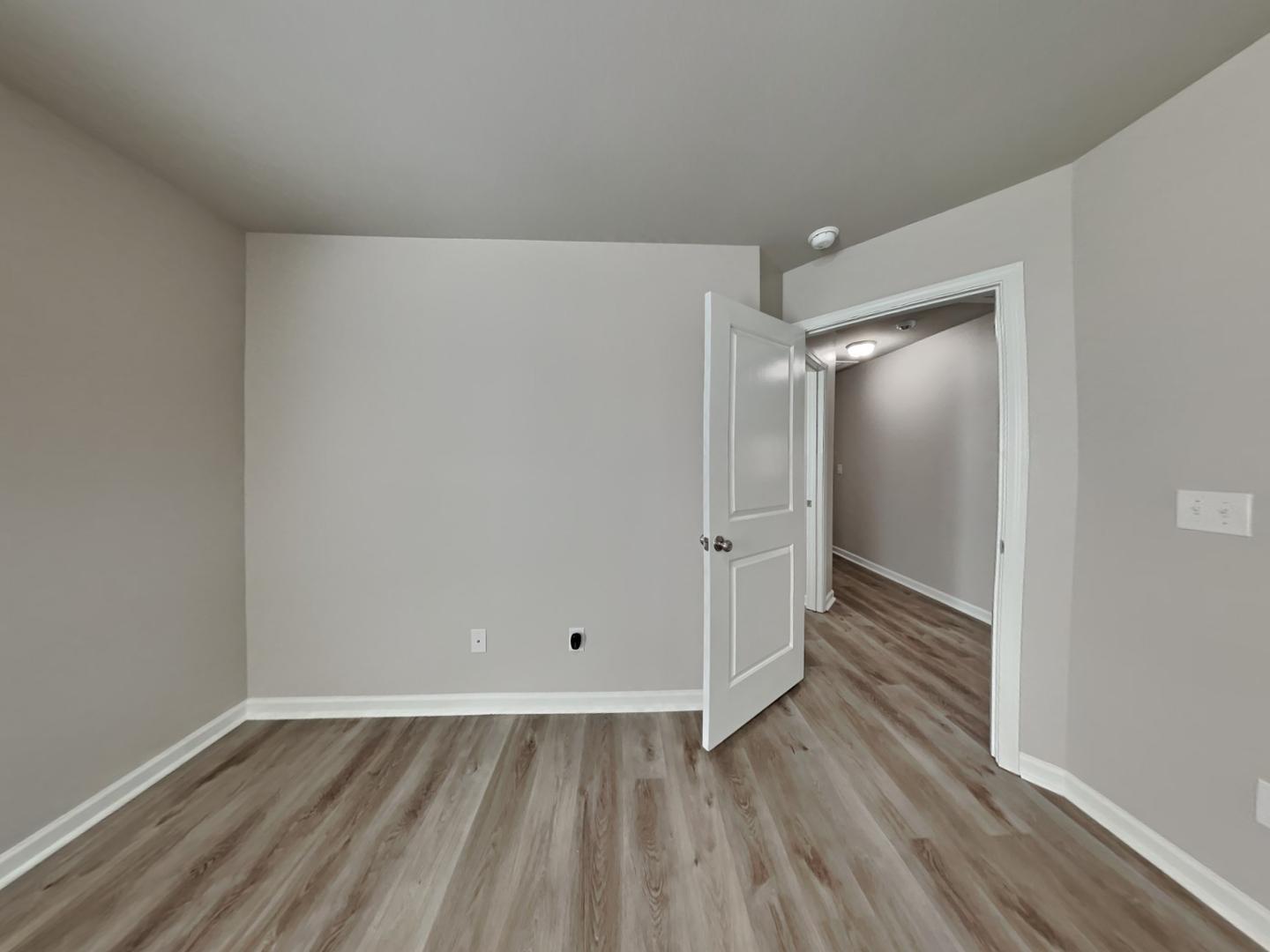 169 Willow Ridge Circle Willow Spring, NC 27592 - Photo 11 of 17 a view of an empty room with wooden floor