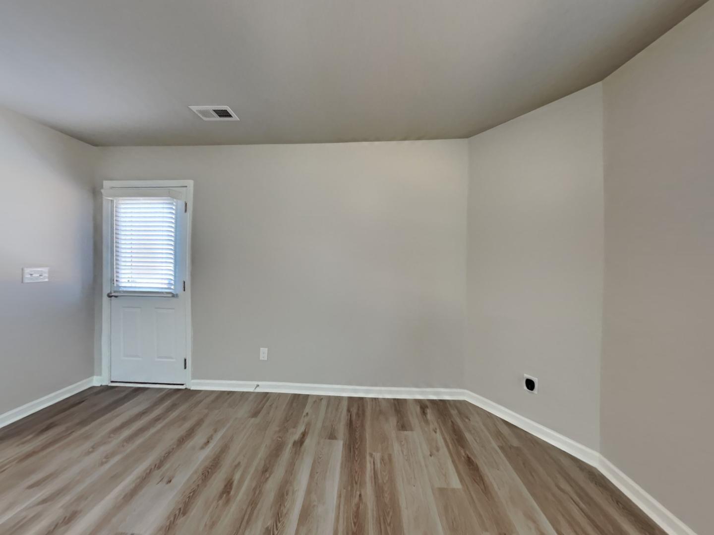 169 Willow Ridge Circle Willow Spring, NC 27592 - Photo 4 of 17 a view of an empty room and wooden floor