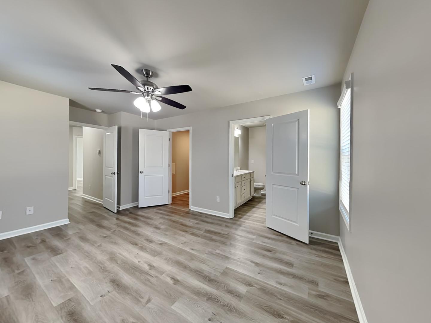 169 Willow Ridge Circle Willow Spring, NC 27592 - Photo 8 of 17 wooden floor in an empty room with a ceiling fan