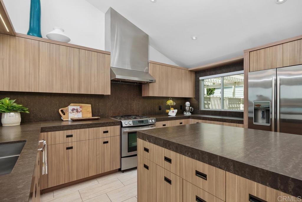 1856 Parliament Road Encinitas, CA 92024 - Photo 12 of 42 a kitchen with granite countertop a stove sink and cabinets