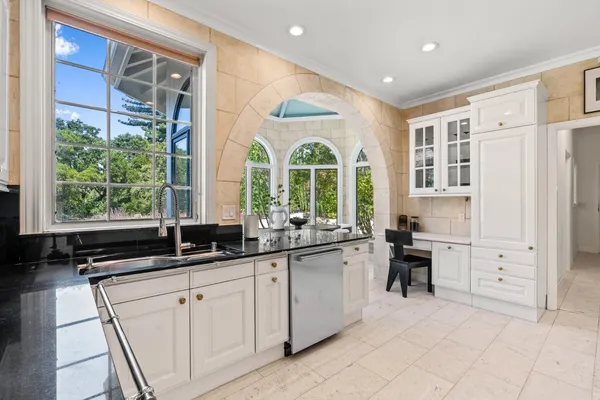 a kitchen with stainless steel appliances a sink stove and cabinets
