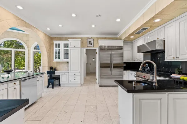 a kitchen with stainless steel appliances granite countertop a sink and cabinets