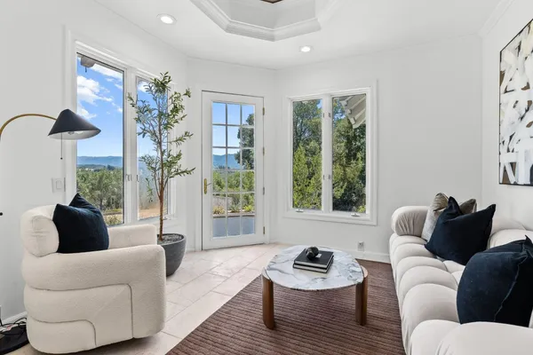 a bathroom with a tub and glass window