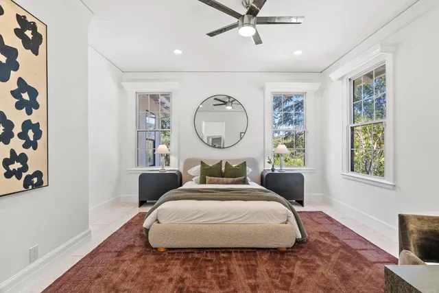 a bathroom with a granite countertop sink a mirror and a shower