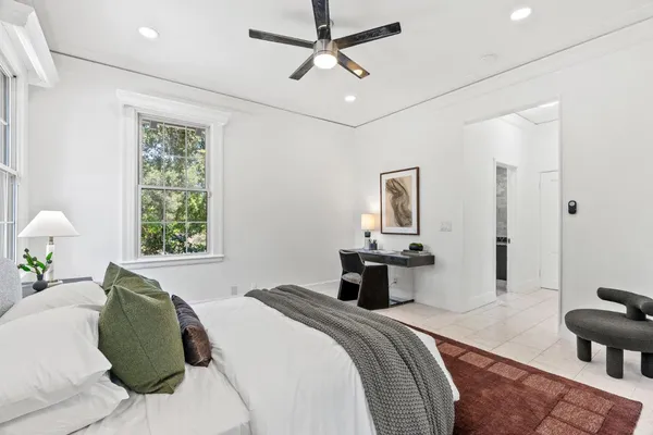 a bedroom with a bed and a window