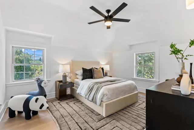 a bedroom with a large bed and a chandelier