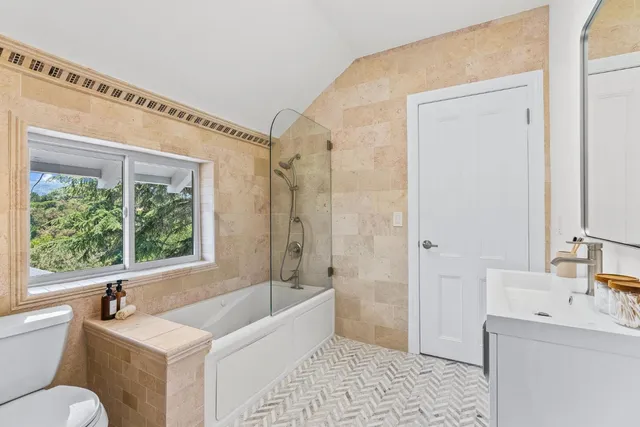 a view of a patio with couches table and chairs and potted plants