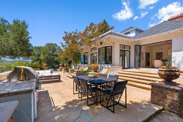 a view of a house with garden and sitting area