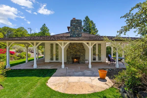 a view of a patio with a table chairs and a backyard