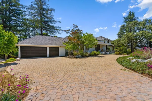 a front view of a house with a yard and a garage