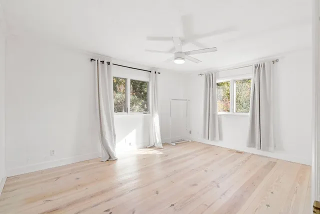 an aerial view of a house with a yard and trees