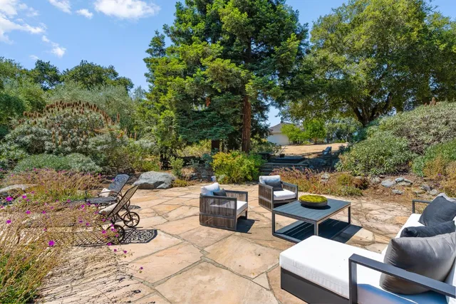an aerial view of a house with a yard and garden