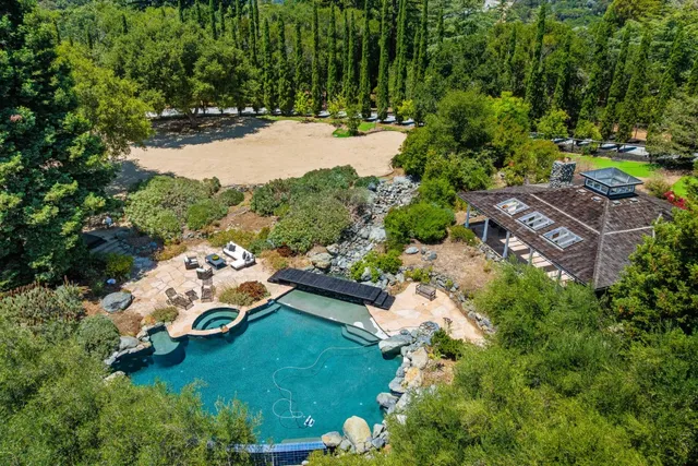 a backyard of a house with table and chairs