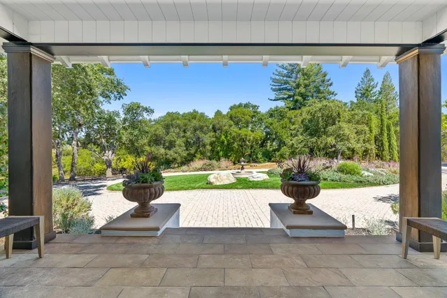 a view of a porch with furniture and a yard