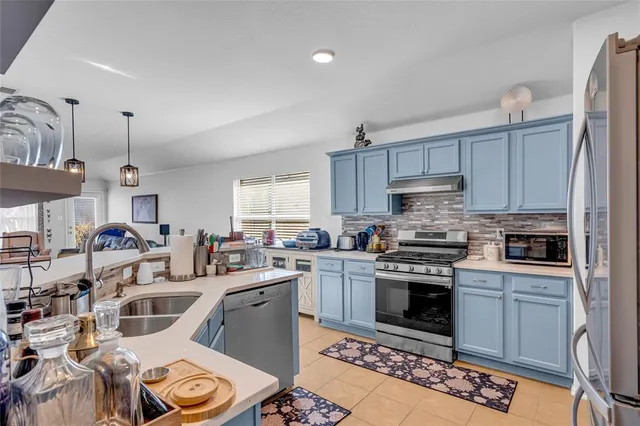 a kitchen with lots of counter top space stove a sink and dishwasher