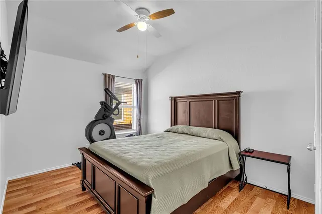 a bedroom with a bed and wooden floor