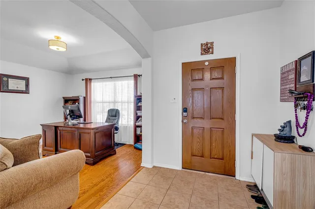 a view of a dining room and livingroom with furniture wooden floor a rug and a chandelier