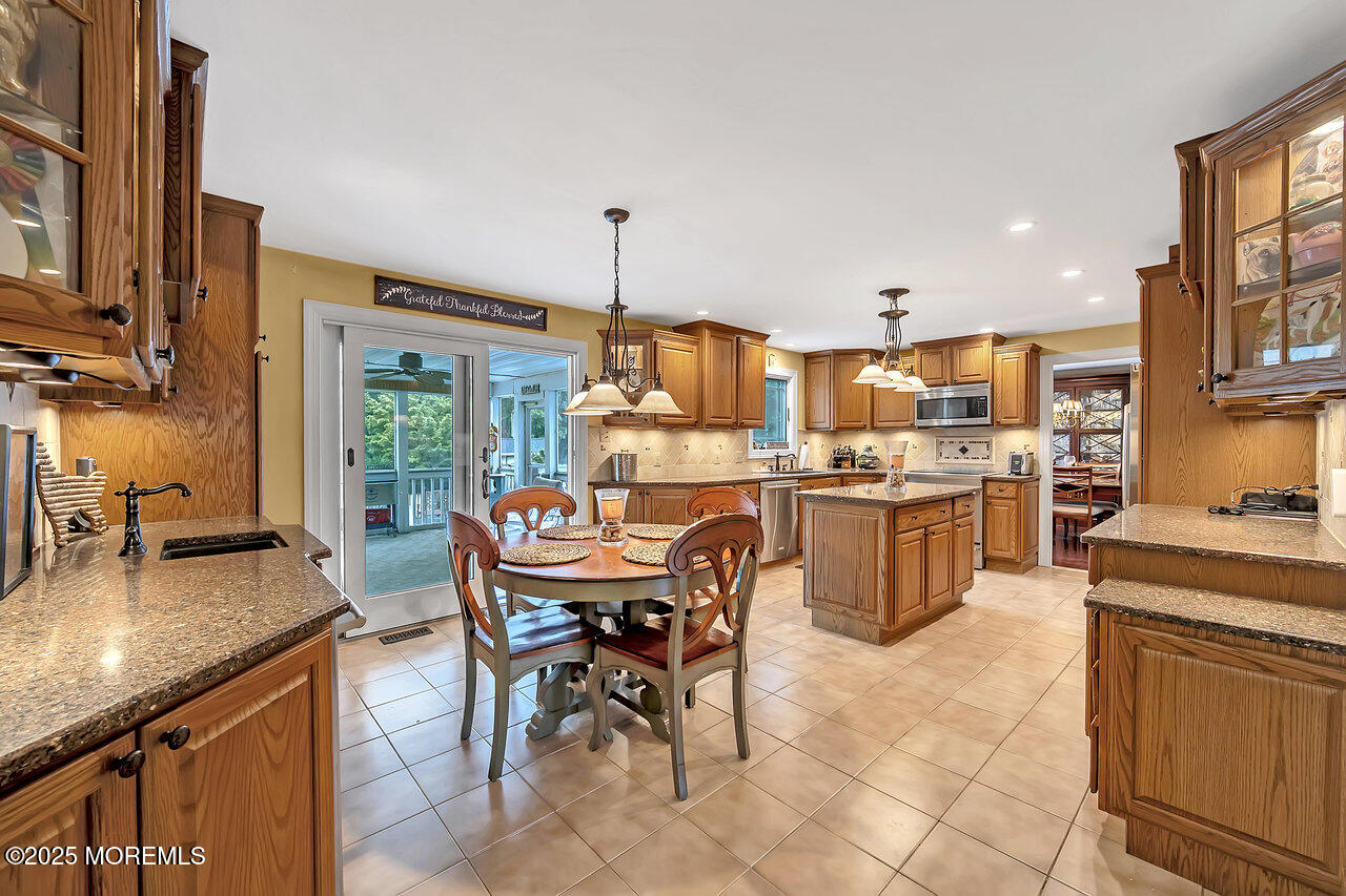 4 Cranberry Court Cream Ridge, NJ 08514 - Photo 3 of 51 a kitchen with a table chairs stove and cabinets