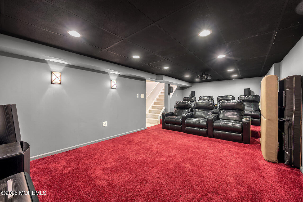 4 Cranberry Court Cream Ridge, NJ 08514 - Photo 33 of 51 a garage with a couch and a flat screen tv