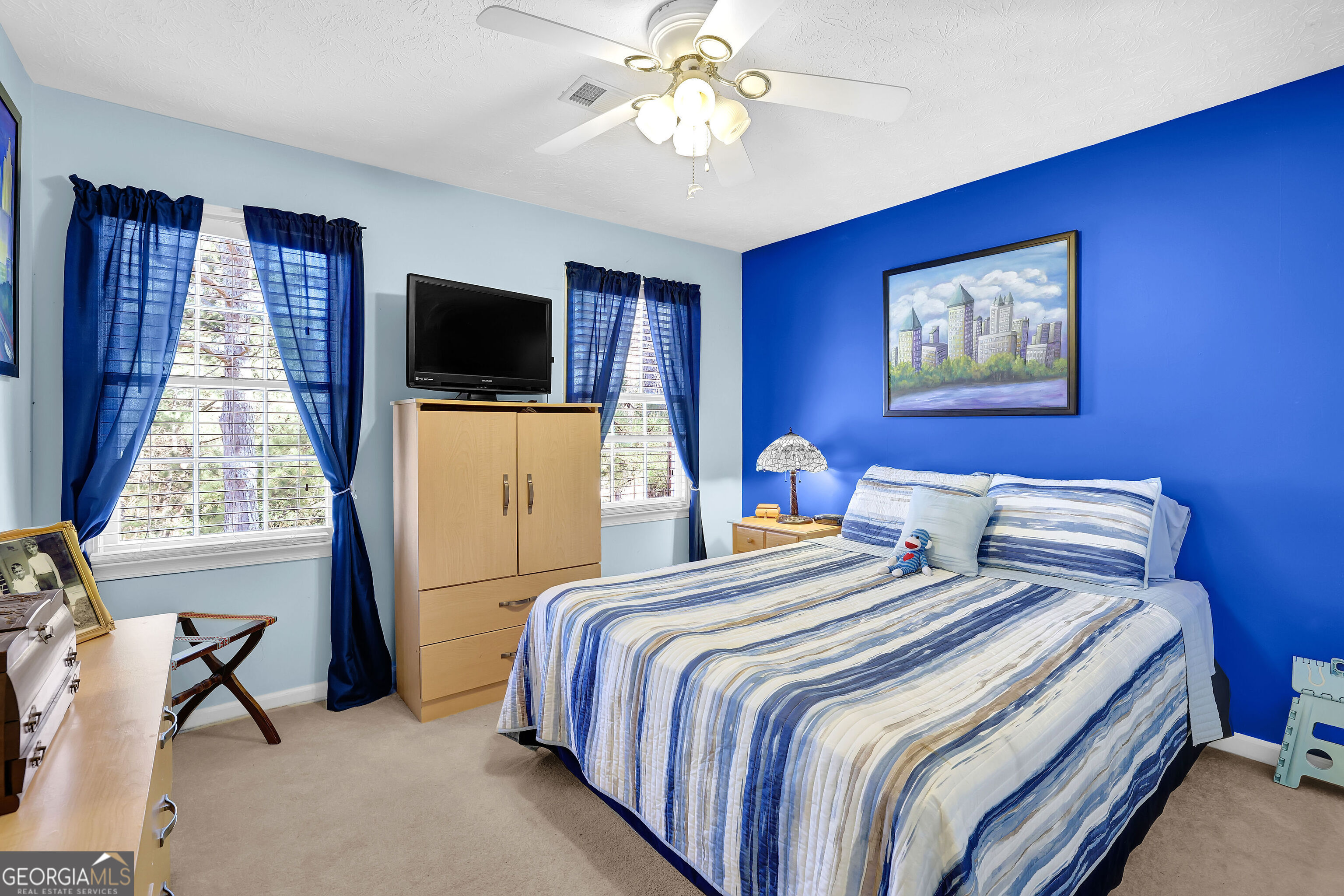 2613 Travois Way Southwest Lilburn, GA 30047 - Photo 16 of 40 a bedroom with bed and tv