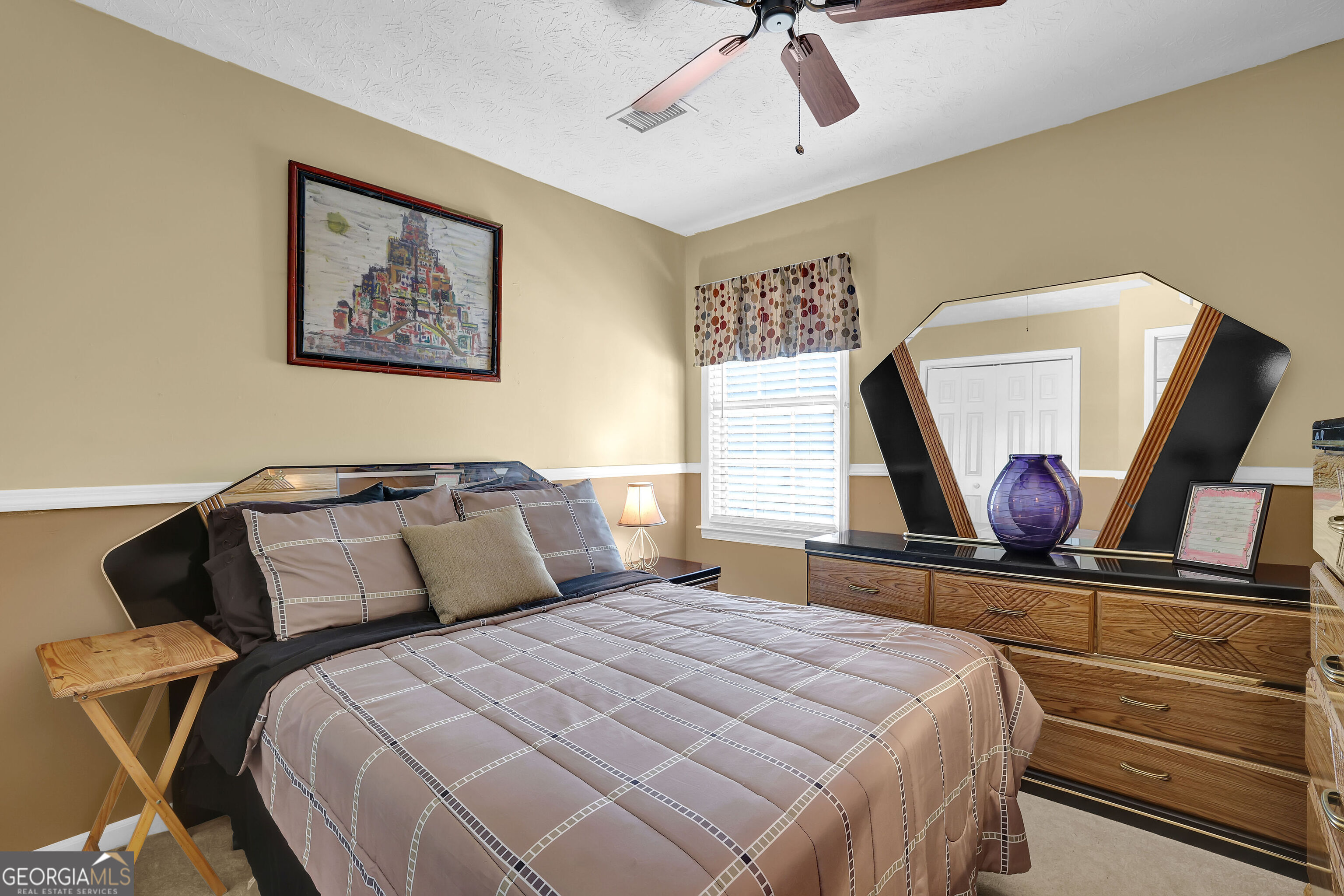 2613 Travois Way Southwest Lilburn, GA 30047 - Photo 17 of 40 a bedroom with a bed and painting on the wall