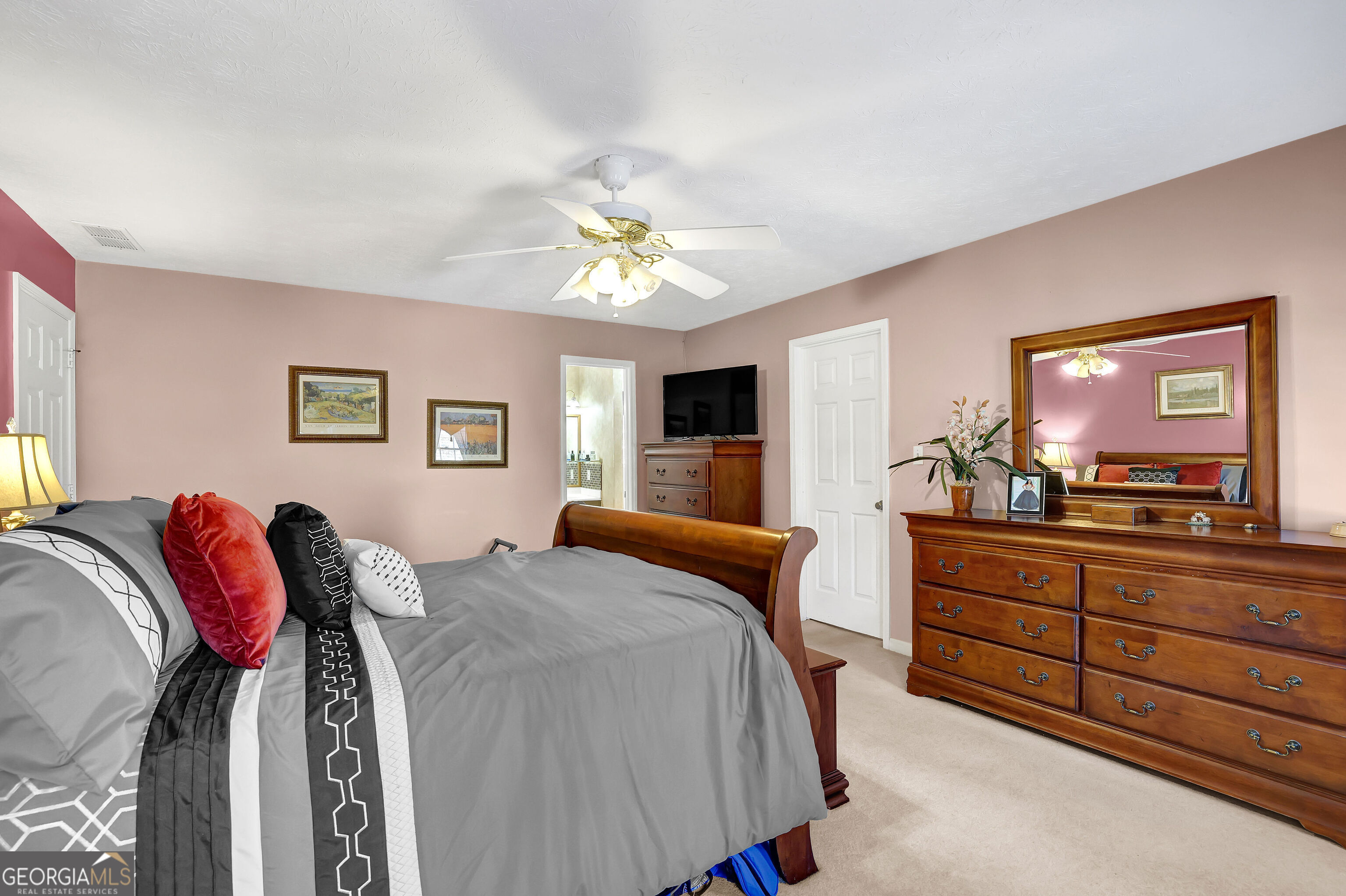 2613 Travois Way Southwest Lilburn, GA 30047 - Photo 20 of 40 a bedroom with a bed and a chandelier