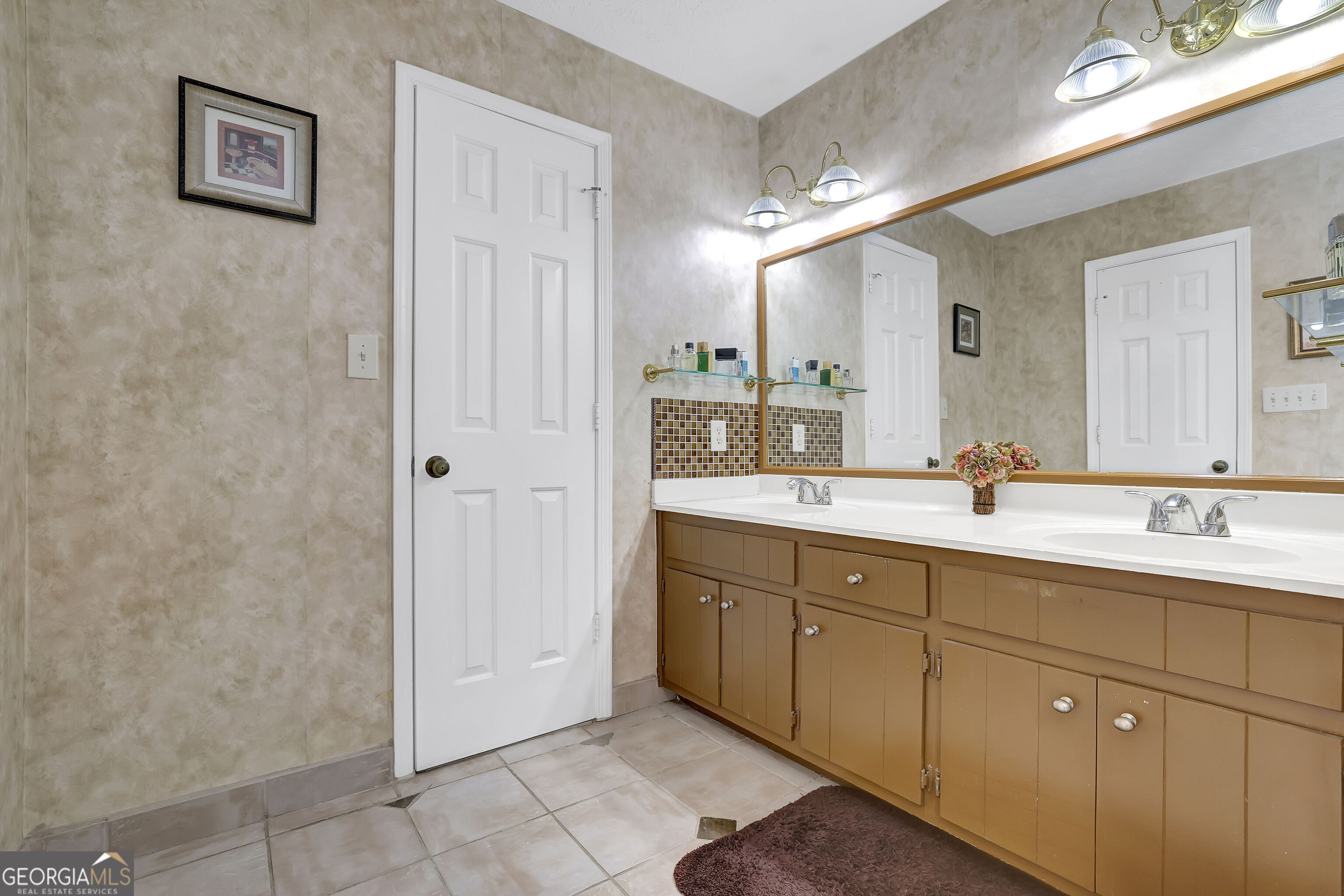 2613 Travois Way Southwest Lilburn, GA 30047 - Photo 22 of 40 a bathroom with a double vanity sink and a mirror