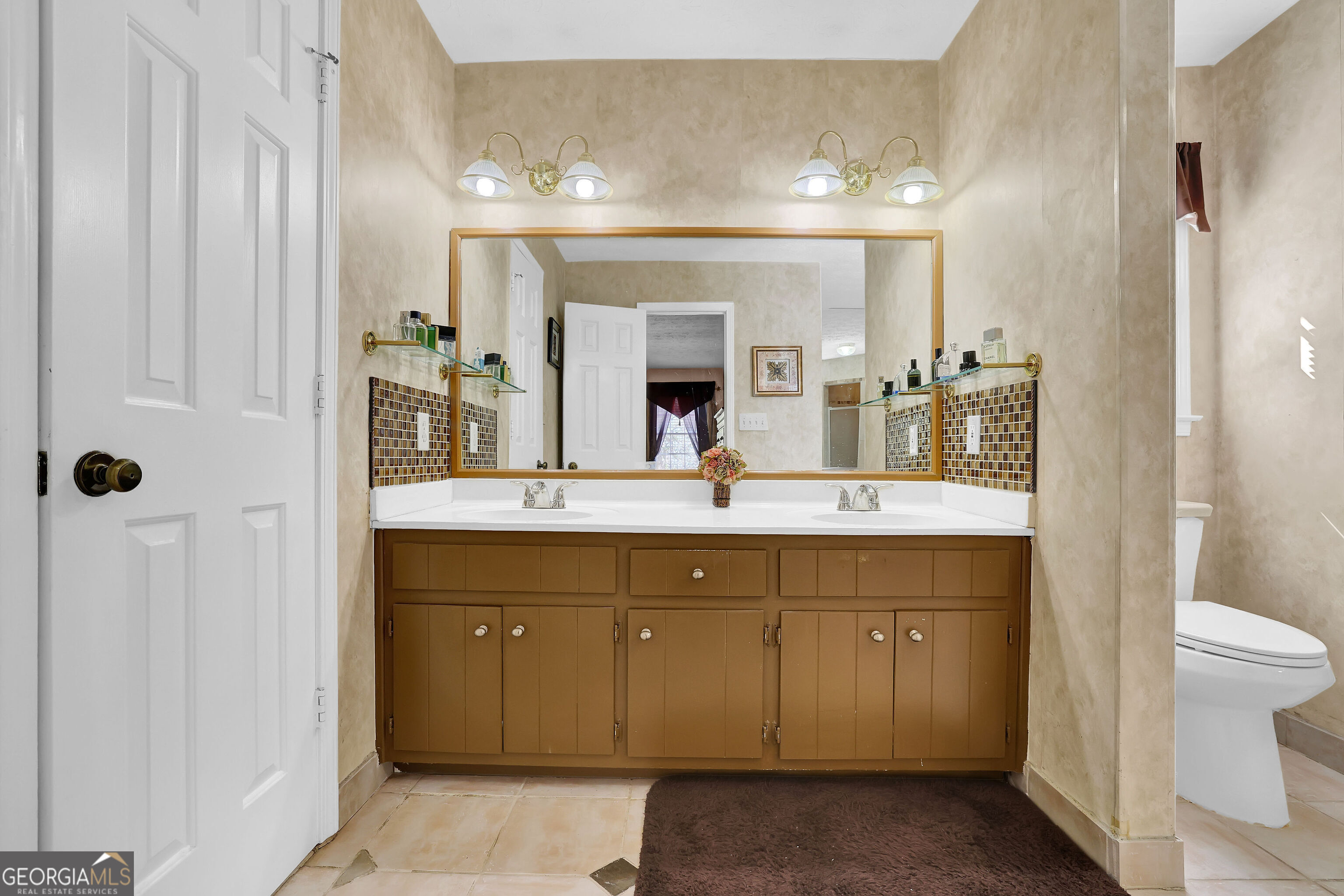 2613 Travois Way Southwest Lilburn, GA 30047 - Photo 23 of 40 a bathroom with a double vanity sink and a mirror