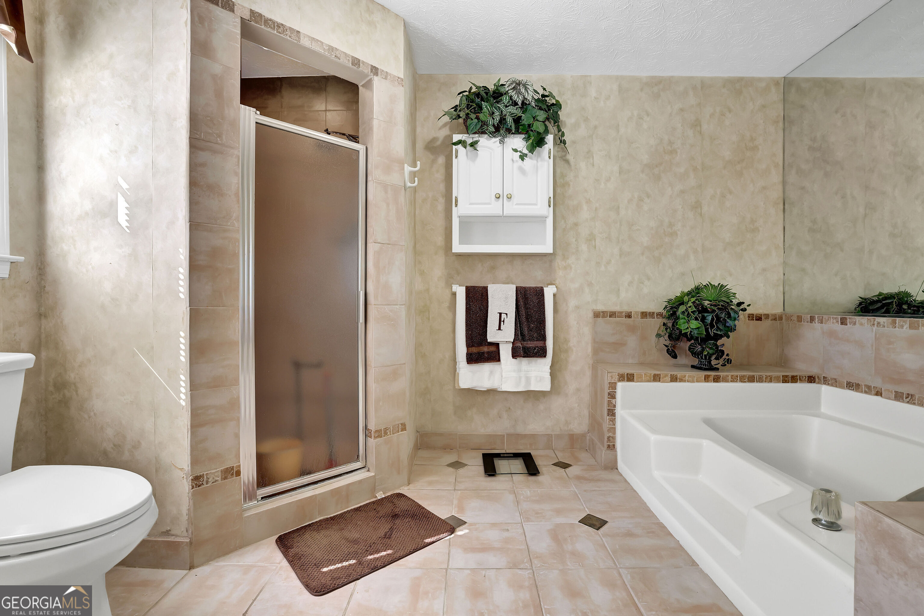 2613 Travois Way Southwest Lilburn, GA 30047 - Photo 25 of 40 a bathroom with a tub toilet and sink